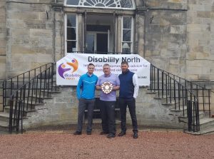 Golf day winning team holding trophy