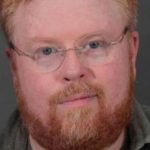image of male, he is wearing glasses and has a beard and a moustache